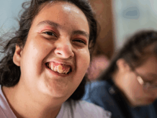 Woman smiling close to the camera.