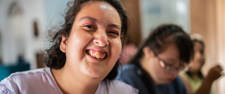 Woman smiling close to the camera.